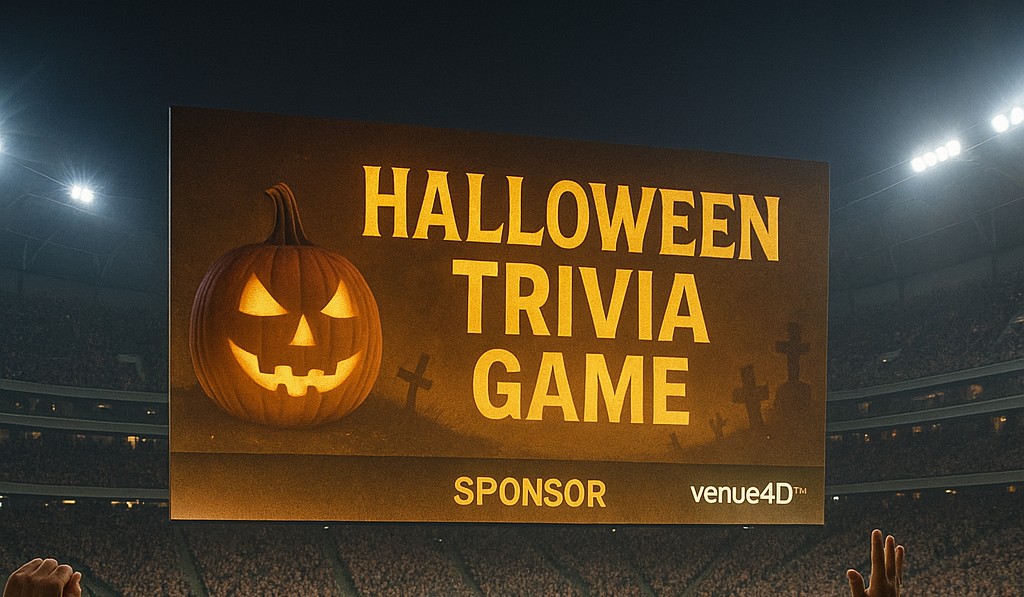 Wide stadium view with fans celebrating during a Halloween-themed trivia game on the video board, featuring sponsor branding and venue4D™ interactive fan engagement.