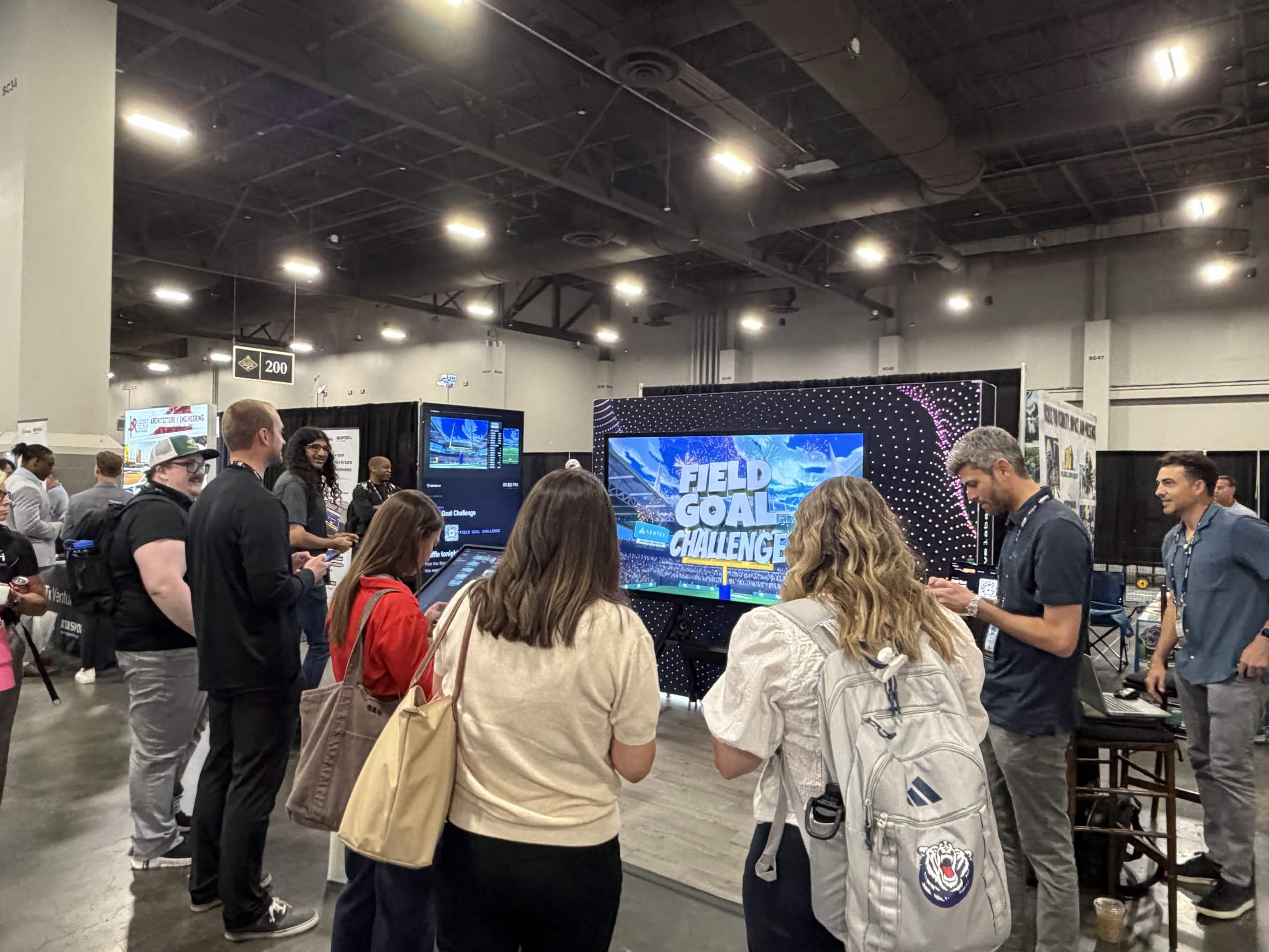 Attendees gather around an interactive 