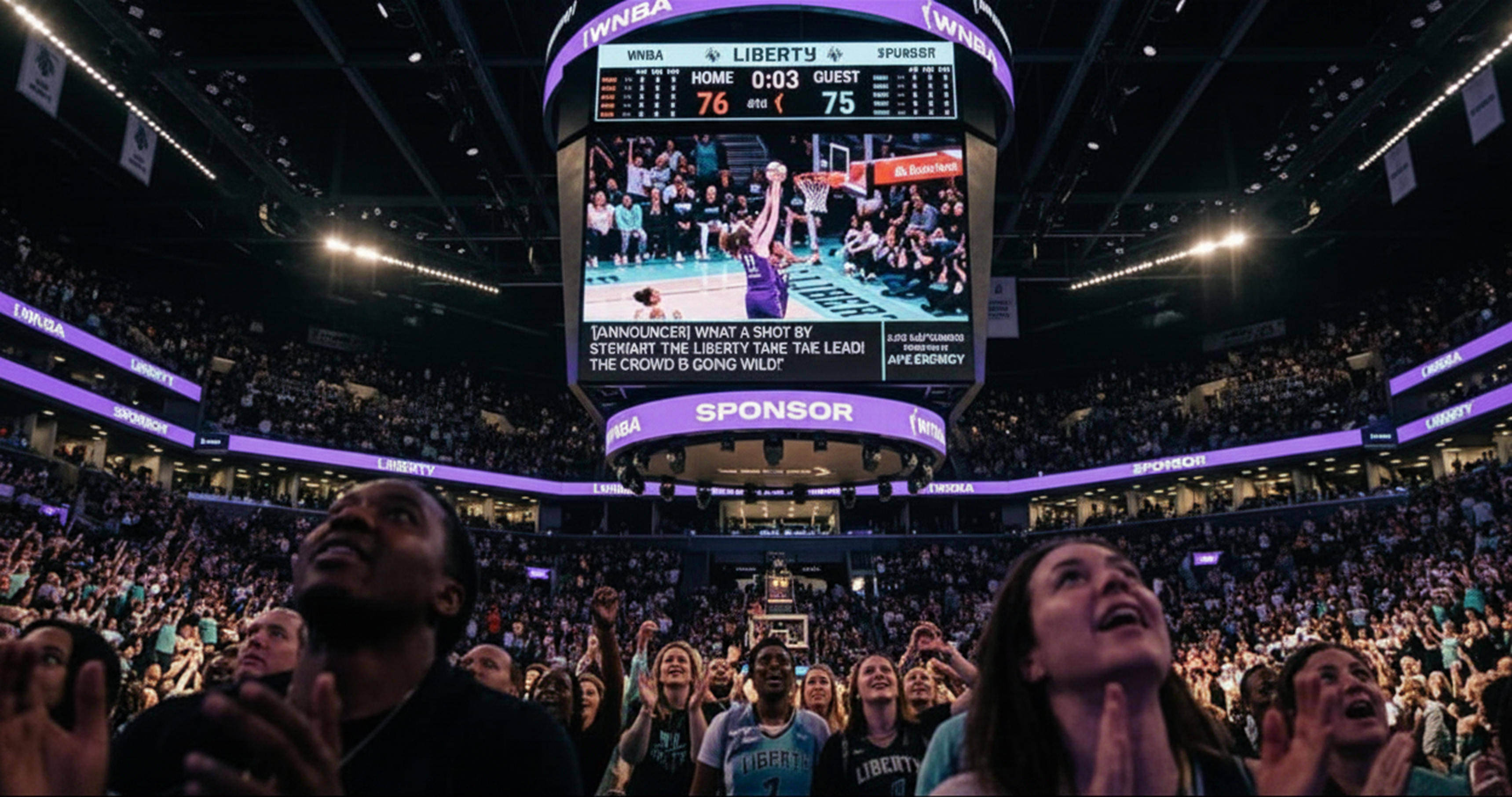 A low-angle photograph taken from the stands of a crowded basketball arena, looking up at a massive, brightly lit jumbotron. The screen displays a replay of a game, and a distinct lower section shows live closed captions. Next to the captions, a logo and text read 